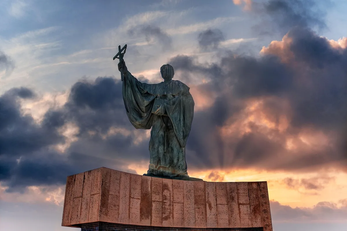 Imagem de santa católica em postura de oração contemplativa